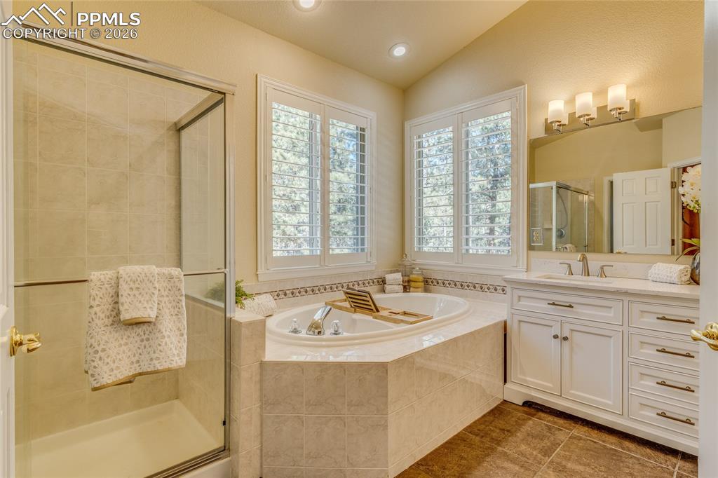 Large soaking tub and walk in shower with corner windows.