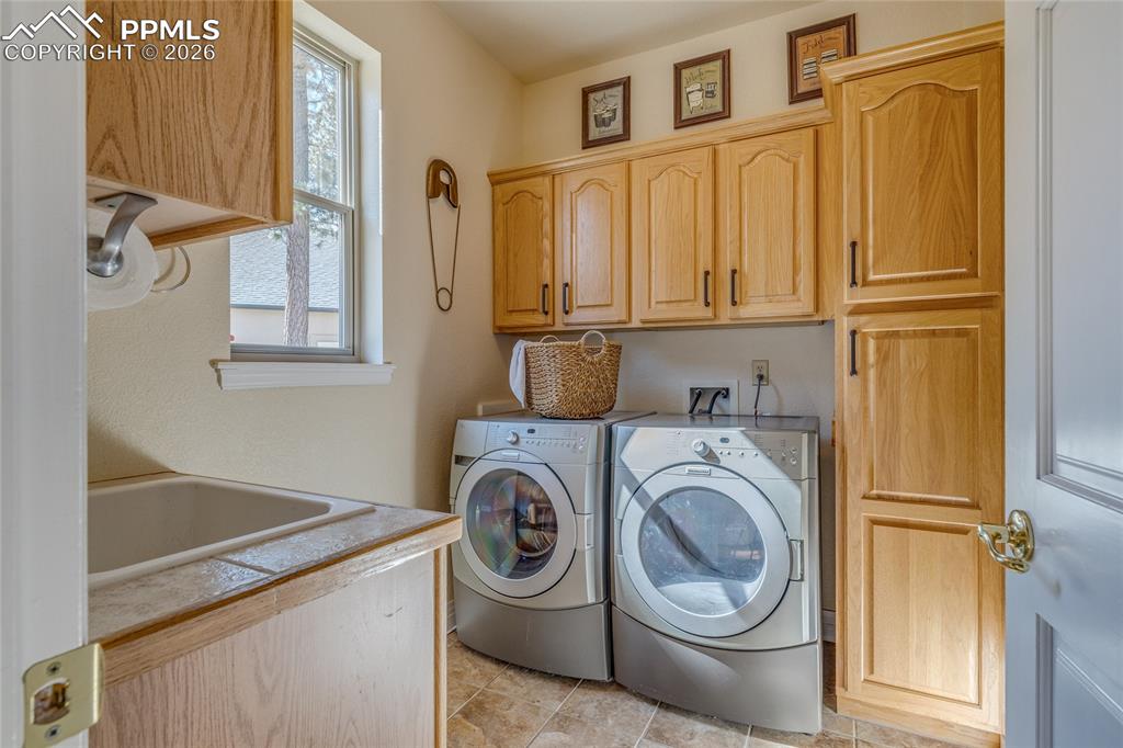 Conveniently located laundry room with great storage and laundry sink.