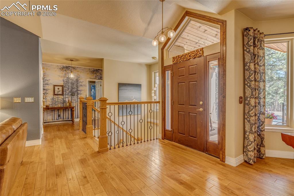 Front entrance looking at the beautiful staircase leading to the basement and the hallway!