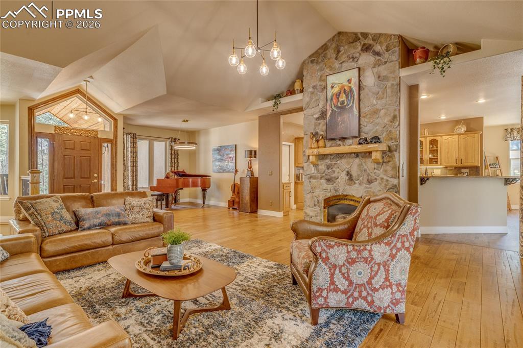 Enjoy the 12' ceilings with the stacked stone fireplace with the stylish lighting.