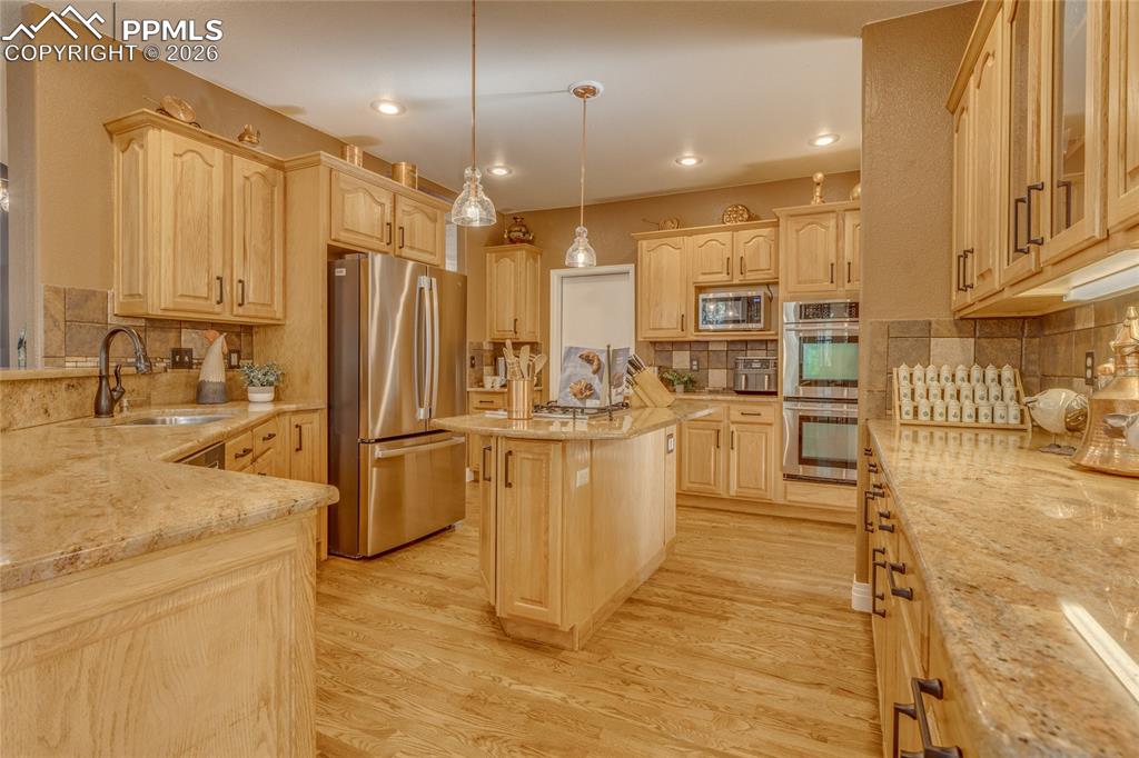 Gourmet kitchen with granite countertops and stainless steel appliances.