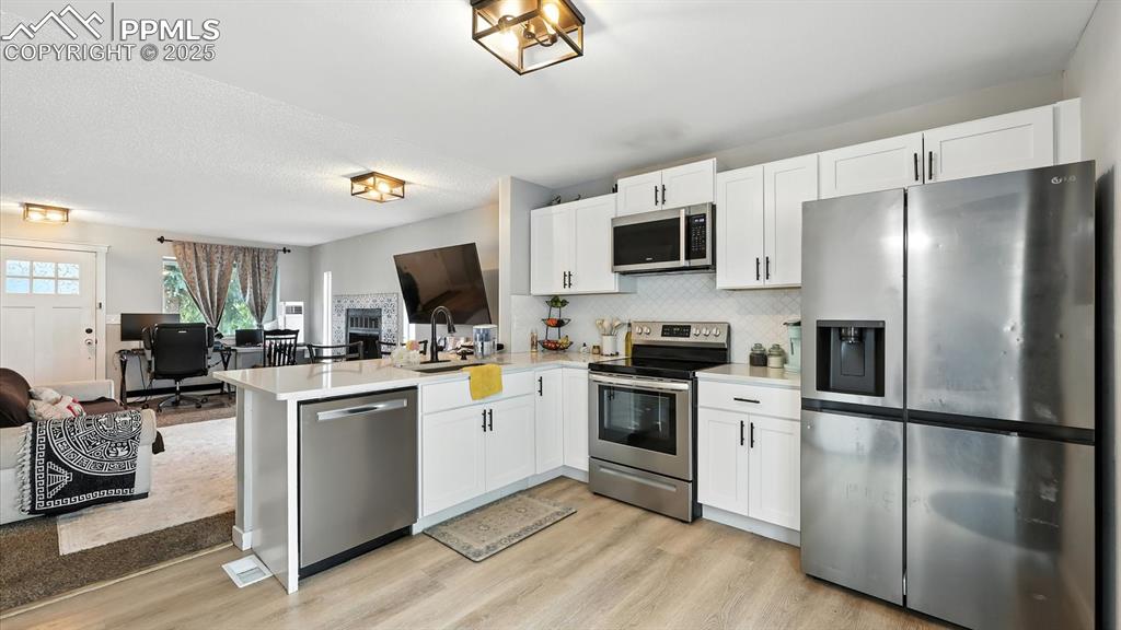 Kitchen appliances include a dishwasher, smooth top range oven, built-in microwave, and French door refrigerator.