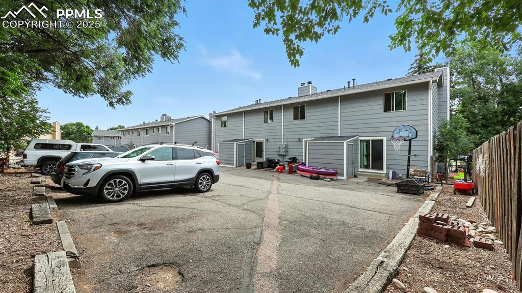Rear view of home with 2 assigned parking spaces.