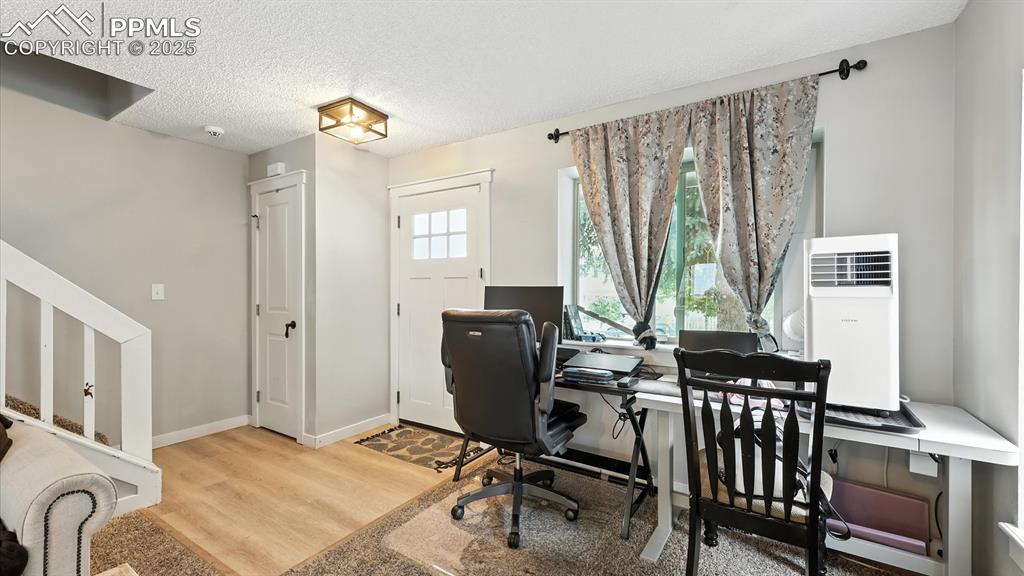 Wood laminate Entry with coat closet that leads into the Living Room.