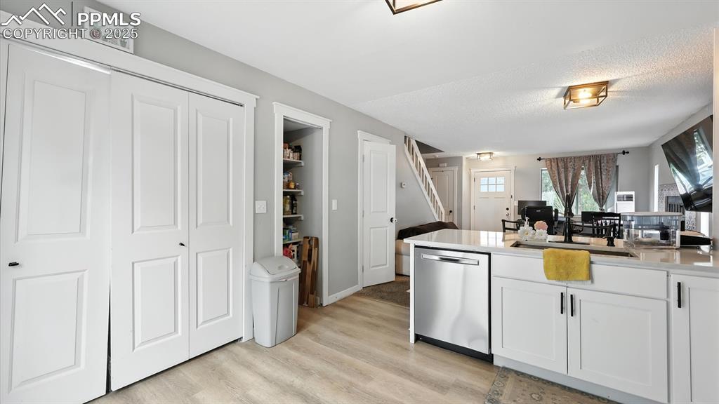 Kitchen with pantry and laundry closet with electrical hookup.