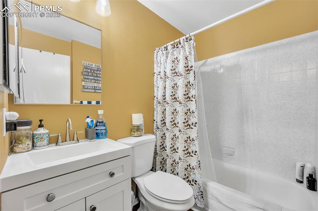 Full bathroom with vanity and shower / bath combination with curtain