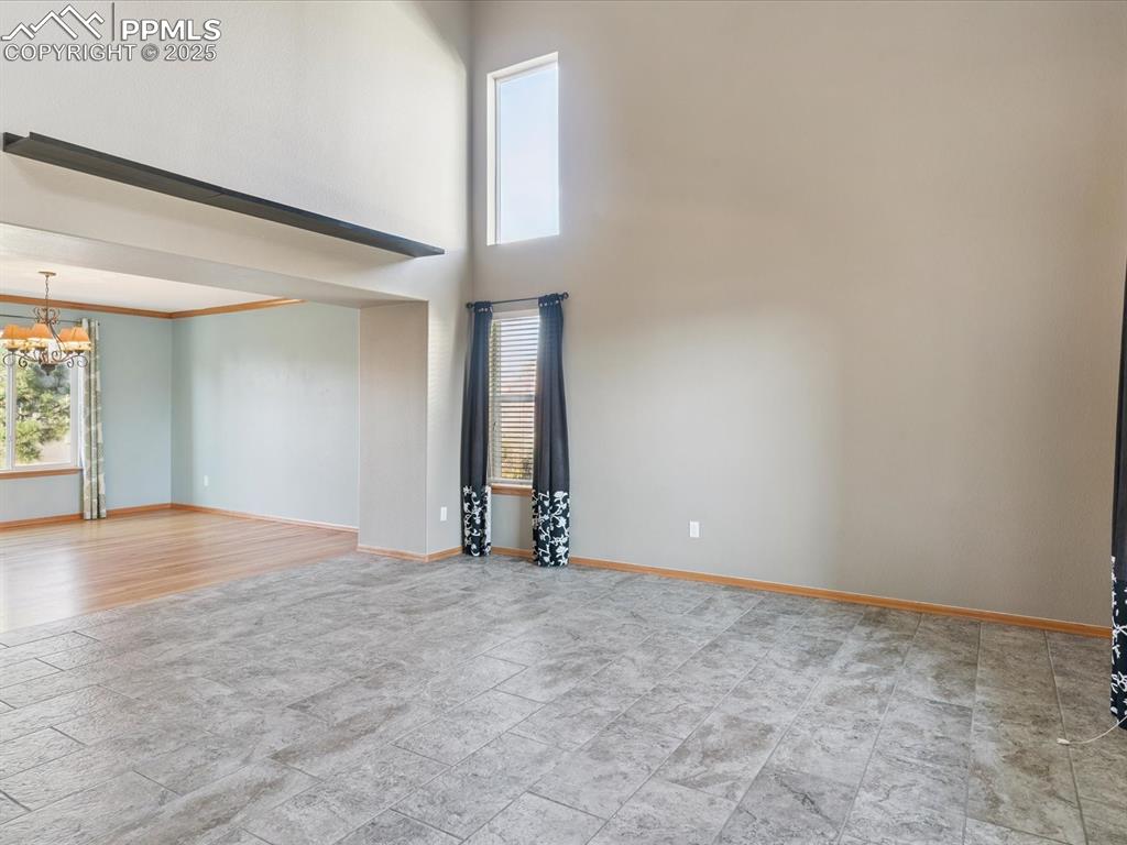 Unfurnished room featuring a high ceiling and a chandelier