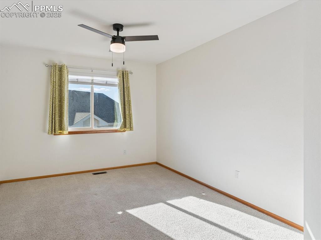 Spare room with carpet flooring and a ceiling fan