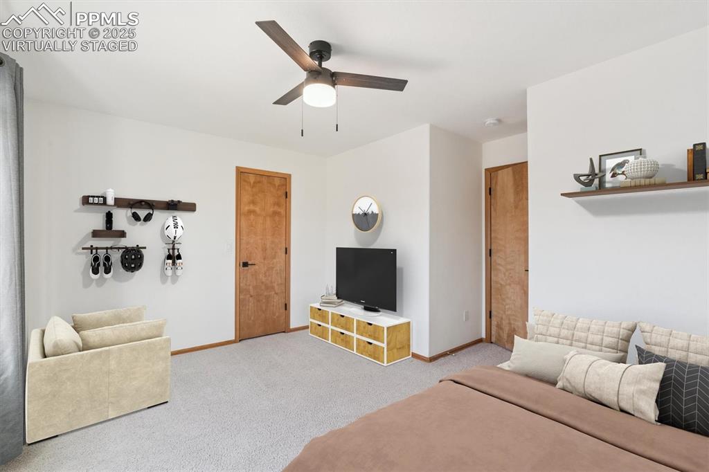 Virtually staged, Carpeted living room featuring baseboards and ceiling fan