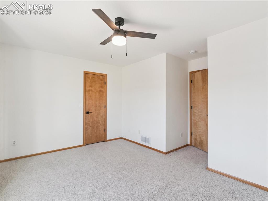 Spare room featuring carpet floors and a ceiling fan