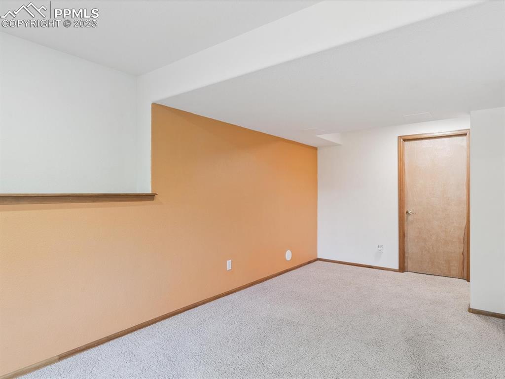 Spare room with carpet and baseboards