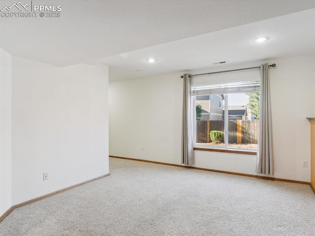 Unfurnished room featuring light carpet and recessed lighting