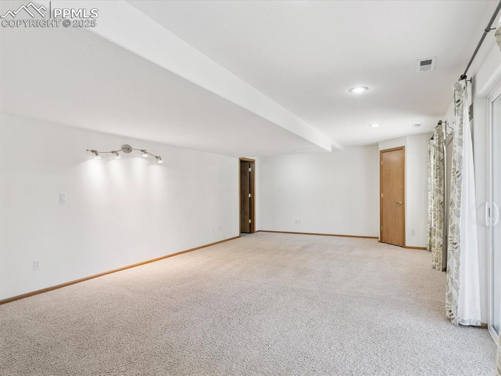 Empty room with carpet and recessed lighting