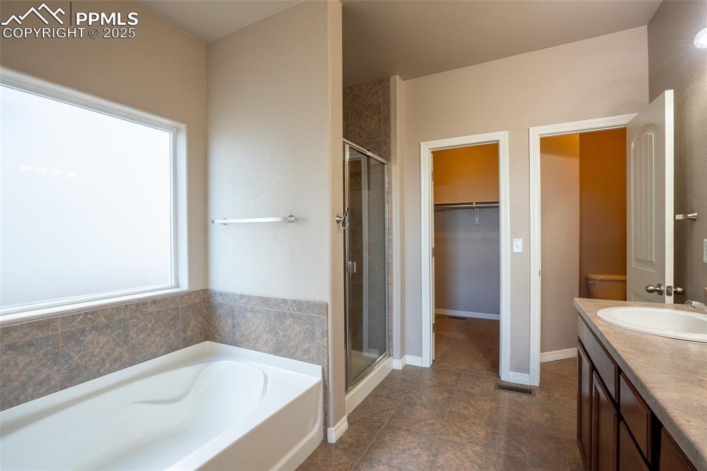 Primary 5 piece bathroom attached with walk in closet (main floor)