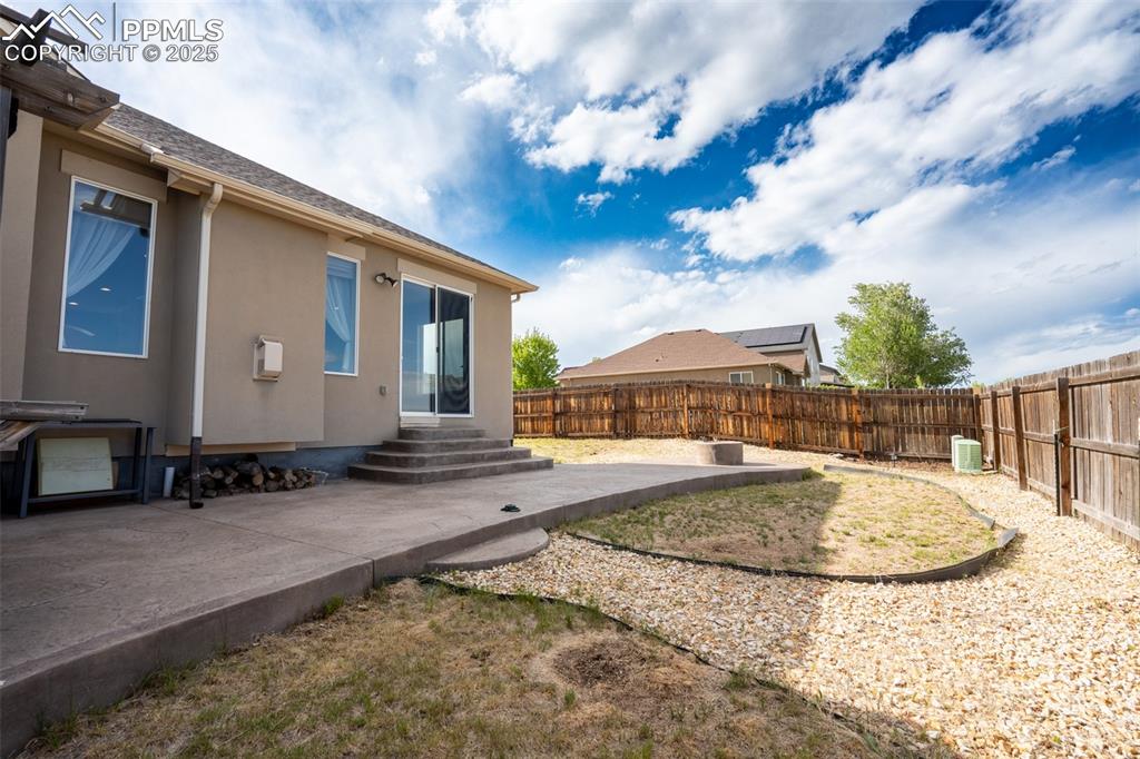 Backyard with stamped concrete, pergola, and fire pit