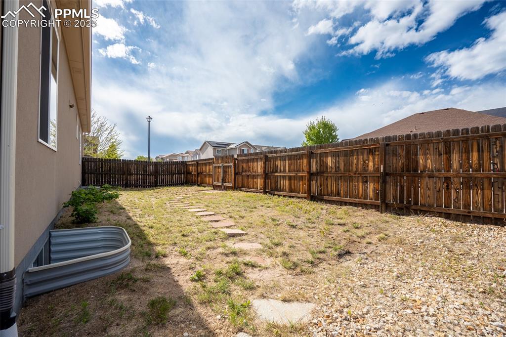 Backyard with stamped concrete, pergola, and fire pit