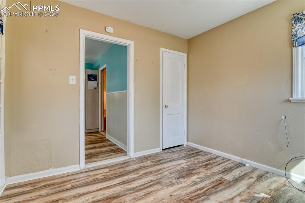 Spare room featuring baseboards and wood finished floors