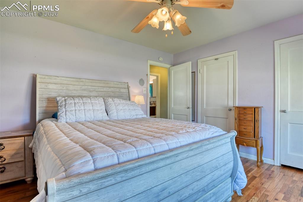 Bedroom with baseboards, a ceiling fan, and wood finished floors