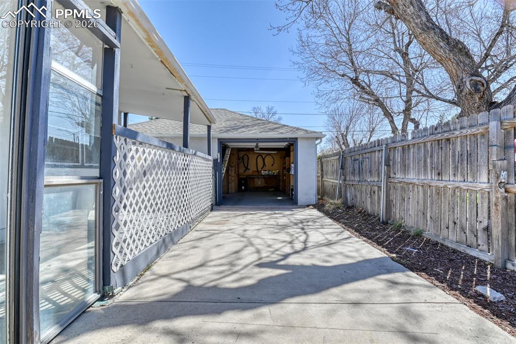 View of patio / terrace with an outdoor structure and fence