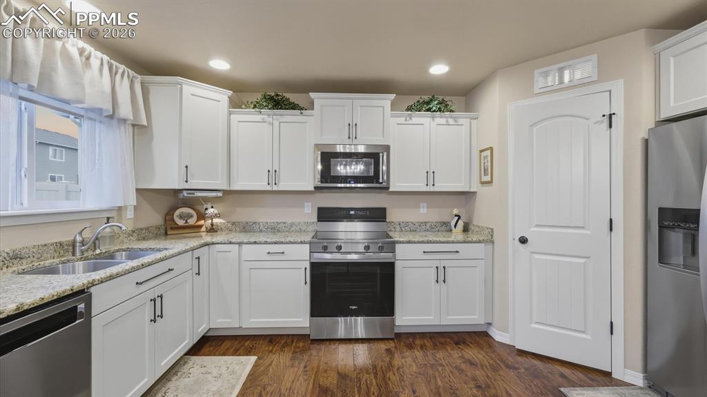 The Eat-In Kitchen boasts white cabinetry, granite countertops, a large pantry, and newer stainless steel appliances