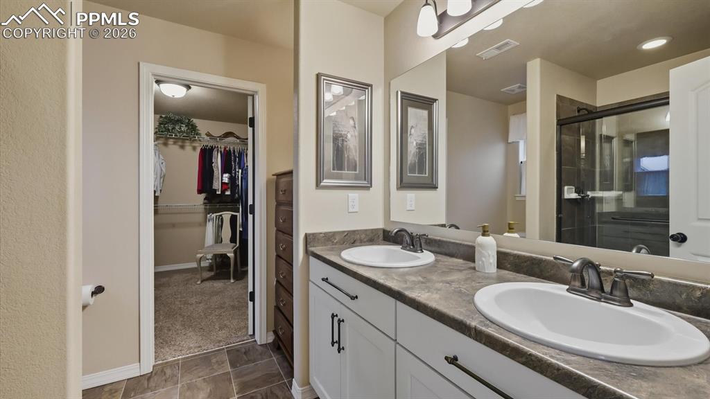 The Primary Bathroom has a dual sink vanity and mirror.