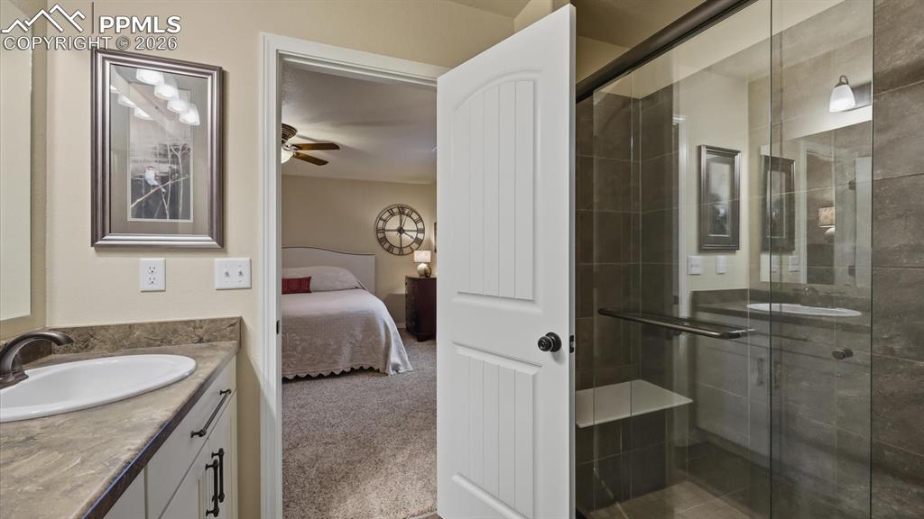 Enclosed tiled shower with built-in seat in the Primary Bathroom.