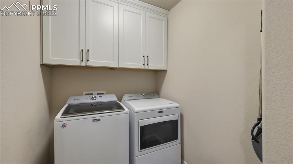 Upper Level Laundry Room with upper cabinets to the ceiling.