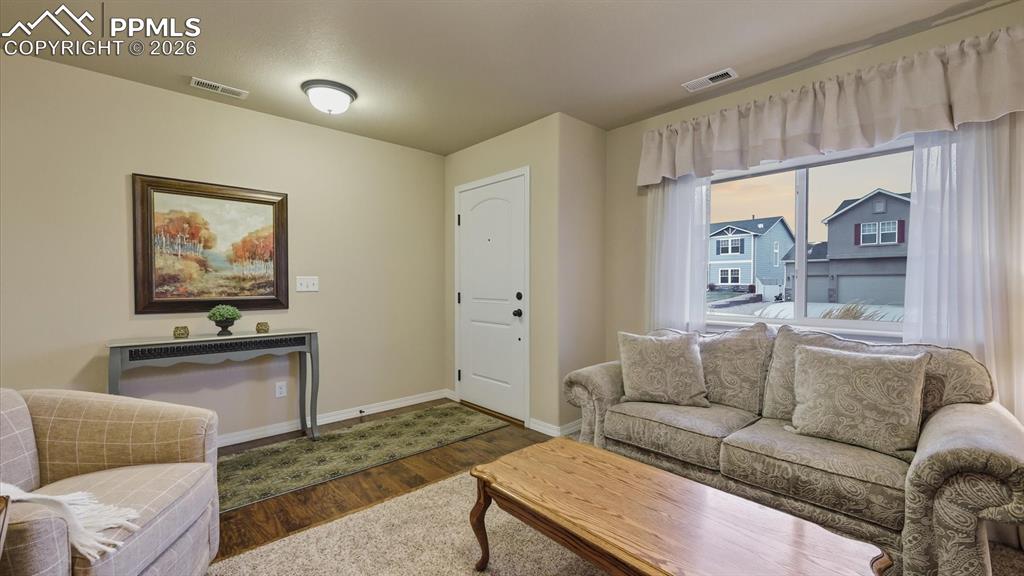 Formal Living Room with large window and front yard views.
