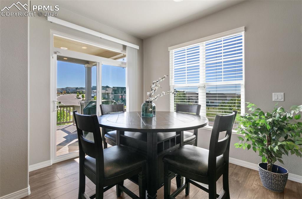 Dining space with wood finished floors and a textured wall