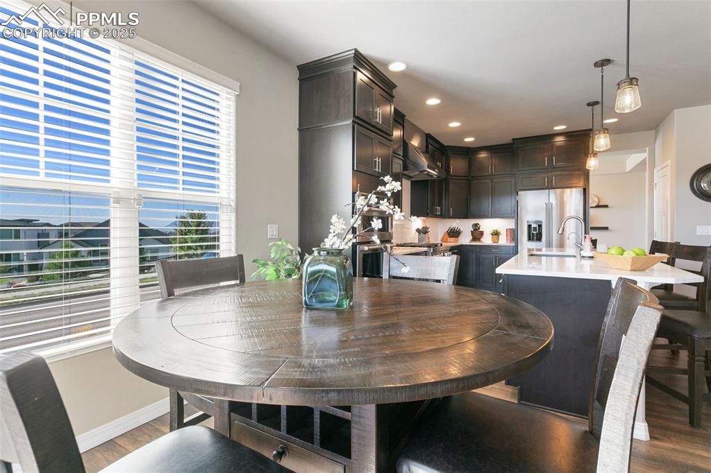 Dining space with recessed lighting and dark wood-type flooring
