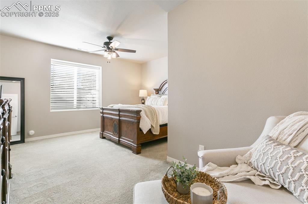 Bedroom featuring light colored carpet and ceiling fan