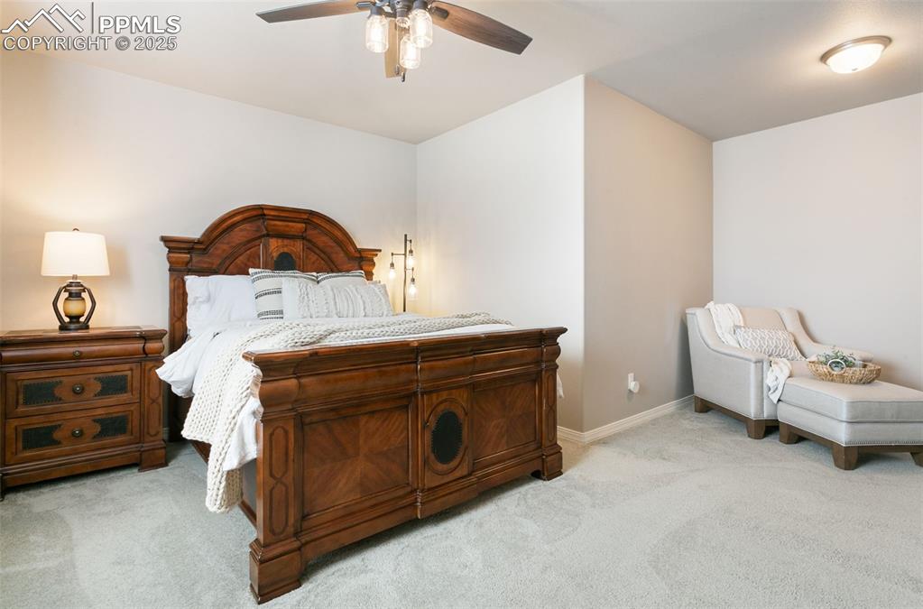 Bedroom featuring light colored carpet and a ceiling fan