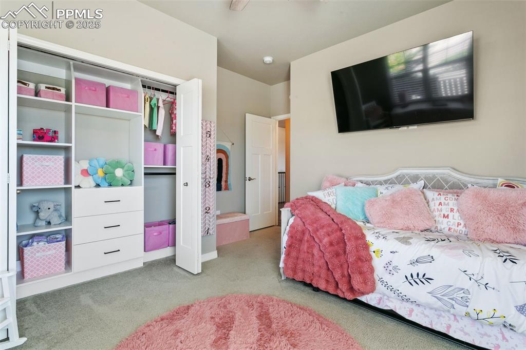 Bedroom with carpet and a closet