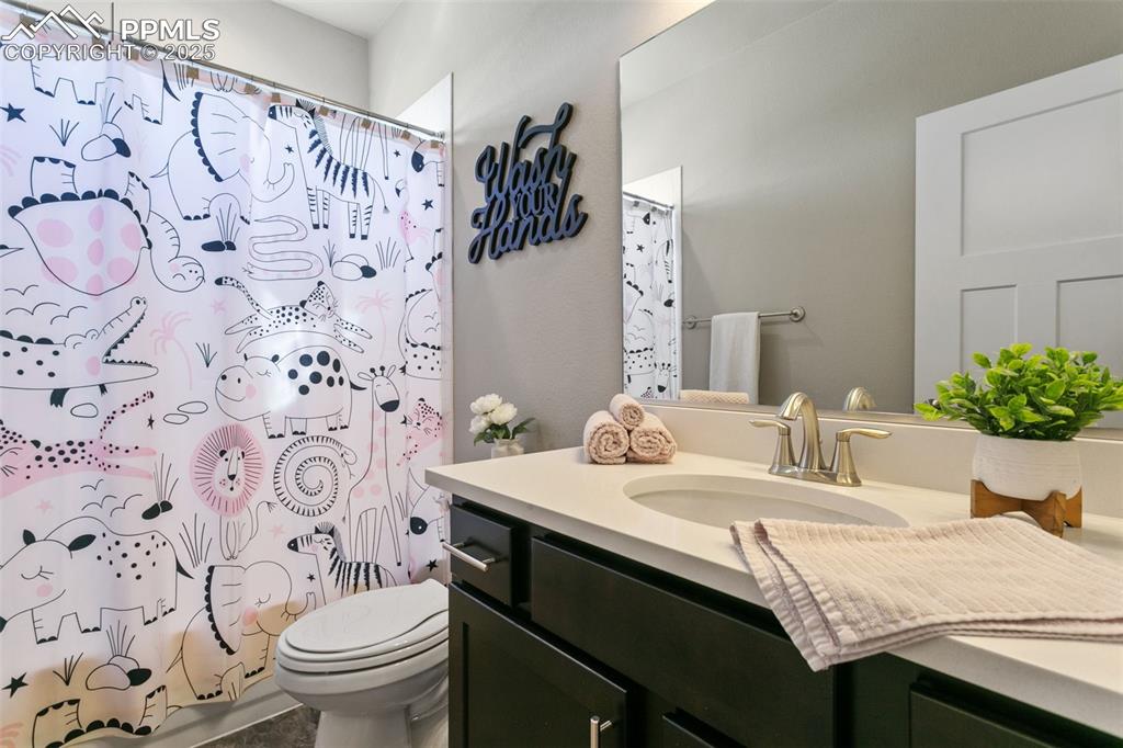 Full bathroom featuring vanity and shower / bath combo with shower curtain