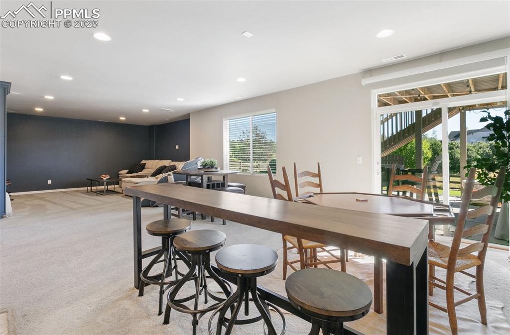 Dining area featuring recessed lighting and light carpet