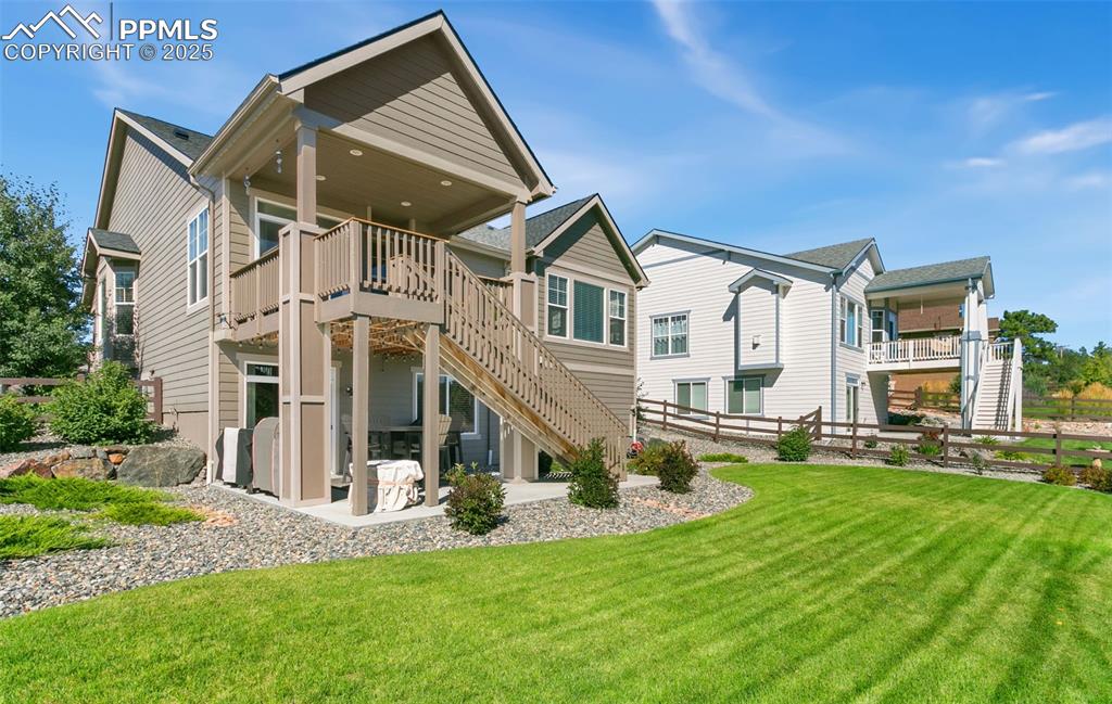 Rear view of property with stairs, a patio, and a wooden deck