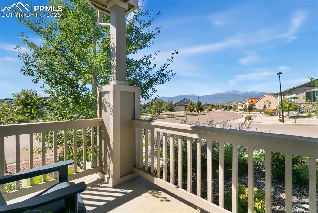 Balcony featuring a residential view and a mountain view