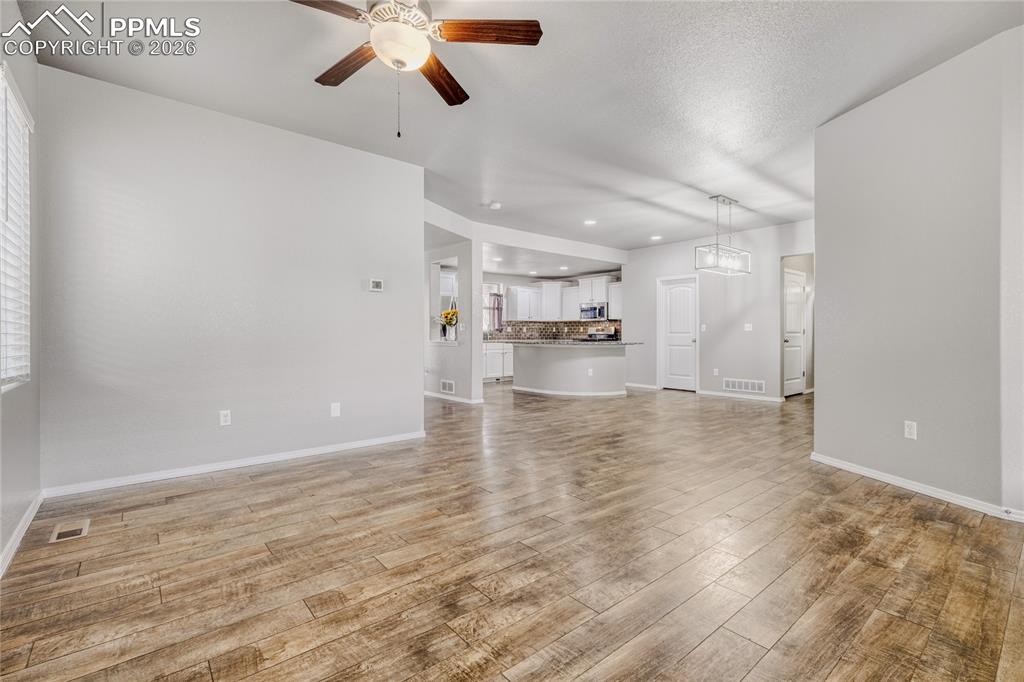 Living room featuring a ceiling fan and LVP floors