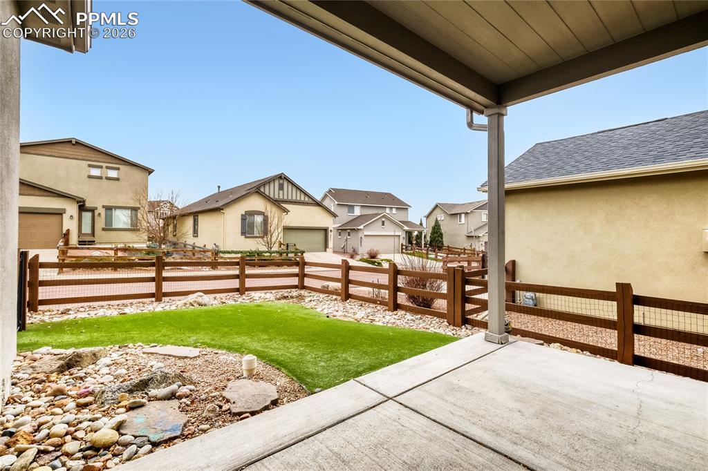 Fenced backyard with a patio and a residential view