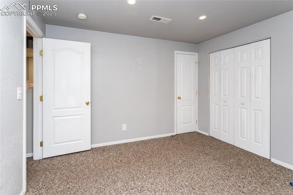 Basement bedroom with both closet and storage closet
