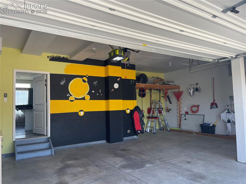 Garage featuring a garage door opener