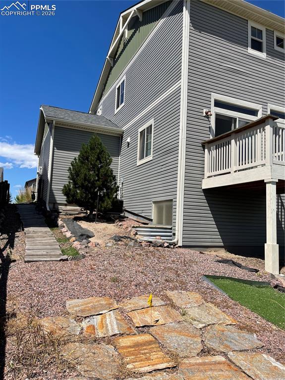 Back of house featuring a wooden deck