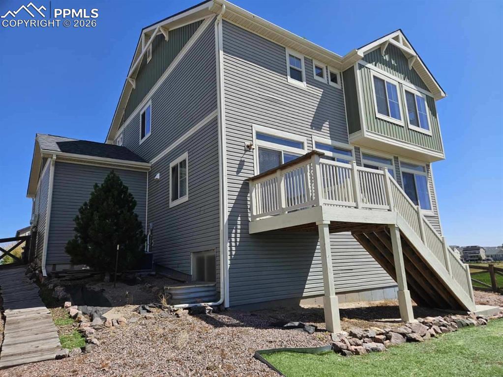 Back of house with a deck and stairway