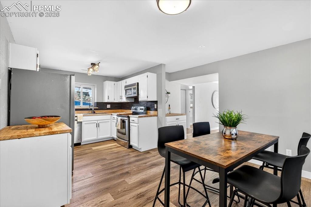 Dining area featuring light wood-type flooring and baseboards