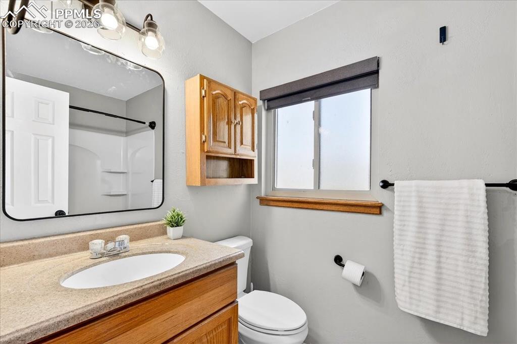 Bathroom featuring vanity and a shower