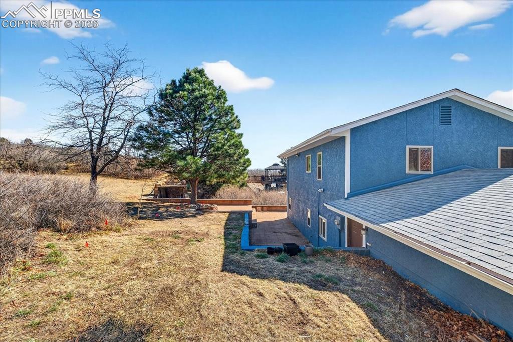 View of home's exterior featuring stucco siding and a yard