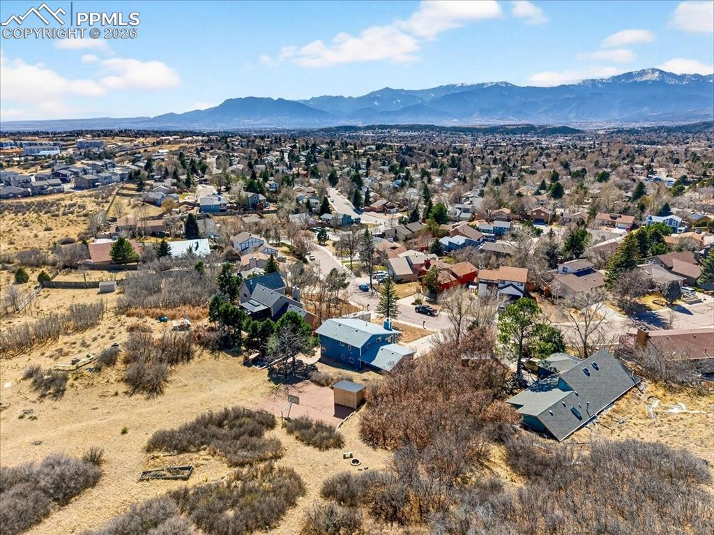 Aerial view of residential area featuring a mountainous background