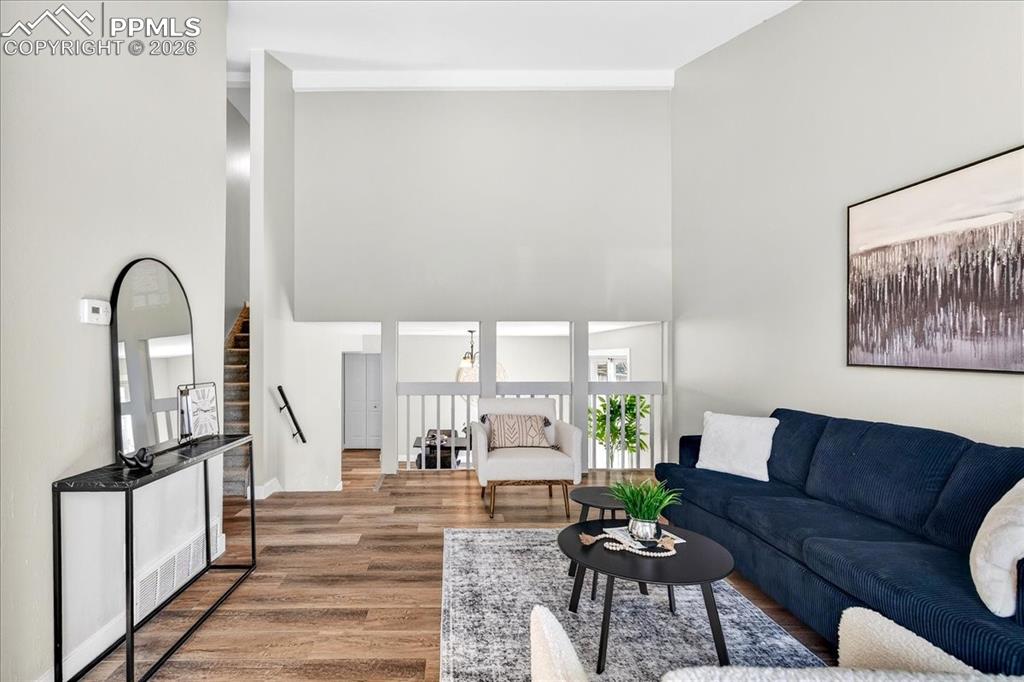 Living room with wood finished floors and a high ceiling