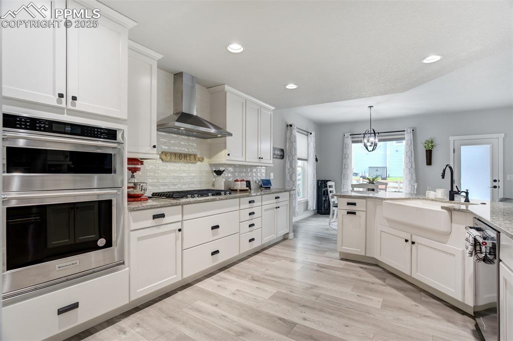Gorgeous kitchen with gas range, hood, and Kitchen aide appliances 