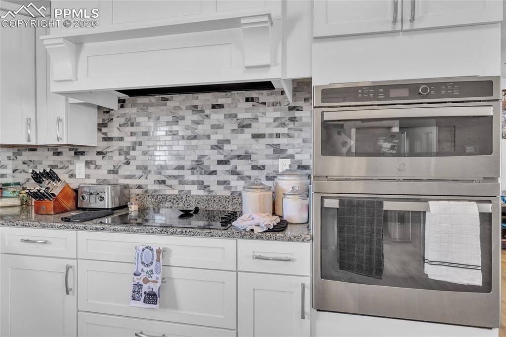 Kitchen with double oven and white cabinets